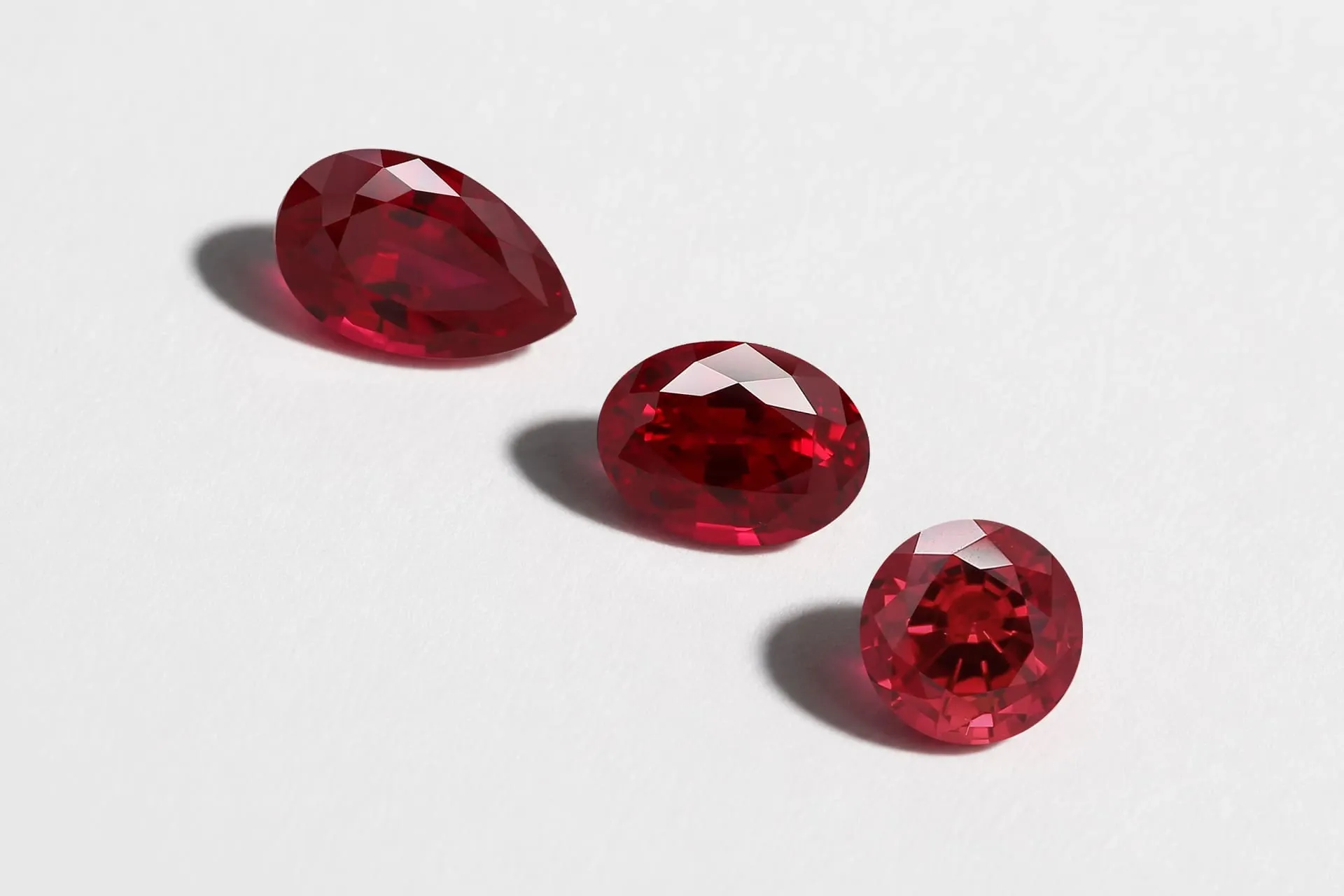 Lab grown ruby gemstones from DEDIAM in pear, oval, and round cuts, showing the rich red color and clarity typical of synthetic corundum ruby